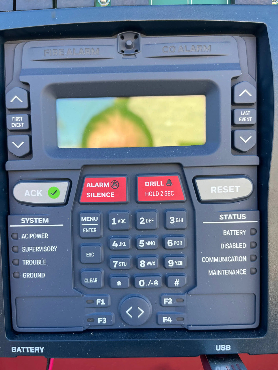 Fire alarm control panel with communicator in a Texas commercial building—monitored 24/7 by a UL central station.