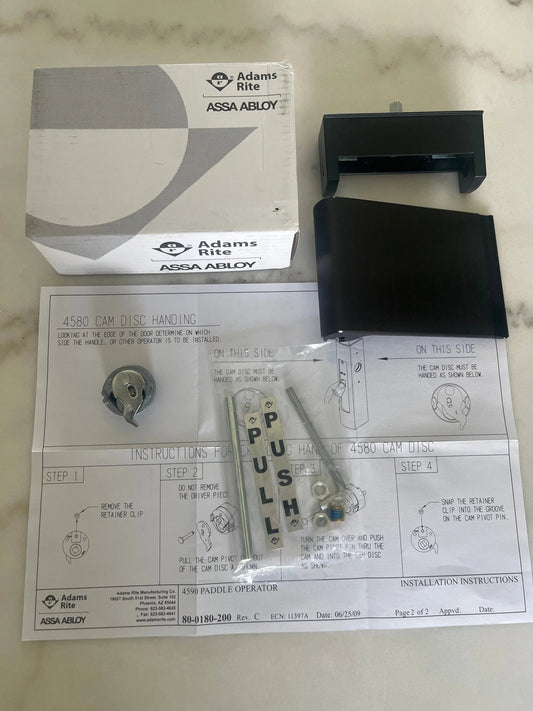 ASSA ABLOY Adams Rite 4590 deadlatch paddle trim in dark bronze (313) for narrow-stile aluminum storefront doors; durable push operation for commercial entries.